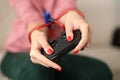 Young woman holding in hands tied with rope joystick from video games computer close-up