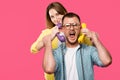 young woman holding handsets and man in eyeglasses screaming isolated