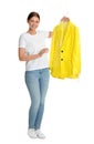 Young woman holding hanger with jacket in plastic bag on background. Dry-cleaning service Royalty Free Stock Photo