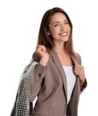 Young woman holding hanger with jacket in bag on white background. Dry-cleaning service Royalty Free Stock Photo