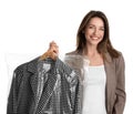 Young woman holding hanger with jacket in bag on white background. Dry-cleaning service Royalty Free Stock Photo