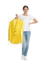 Young woman holding hanger with jacket in plastic bag on background. Dry-cleaning service Royalty Free Stock Photo