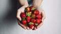 Young woman holding heap of red berries in hands. Fresh healthy vegan dietary food for spring detox. Fruits background. Clean