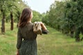 Young woman holding heeled shoes in hand, walking barefoot in green summer park outdoor, environmental friendly concept, Royalty Free Stock Photo