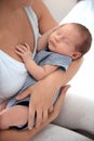 Young woman holding her baby near breast Royalty Free Stock Photo