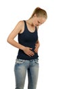 Young woman is holding her belly in pain