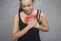 A young woman is holding her chest, Possible heart attack or other heart disease, front view Royalty Free Stock Photo