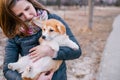 Young woman holding her Corgi puppy outdoors Royalty Free Stock Photo