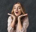 Young woman is holding her face in astonishment Royalty Free Stock Photo