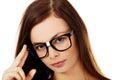 Young woman holding her glasses Royalty Free Stock Photo