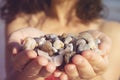 Young woman holding on her hand the beautiful colorful pebbles Royalty Free Stock Photo