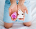 Young woman holding at her hands menstrual cup and tampons