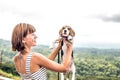 Young woman holding her puppy beagle dog in nature of tropical Bali island, Indonesia. Royalty Free Stock Photo