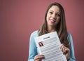 Young woman holding her resume