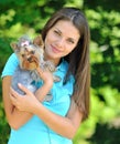 Young woman holding her sweet little puppy - outdoor portrait Royalty Free Stock Photo