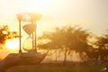 Young woman holding Hourglass during sunset. vintage style. Royalty Free Stock Photo