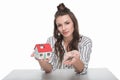 Young woman holding house model with keys and smiling at camera Royalty Free Stock Photo