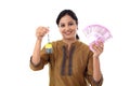 Young woman holding house shape key and 2000 rupee notes Royalty Free Stock Photo