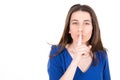 Young woman holding index finger on lips shh silence to secret aside copy space Royalty Free Stock Photo