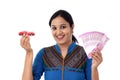 Young woman holding indian currency and toy car against white Royalty Free Stock Photo