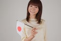 Young woman holding Japanese flag