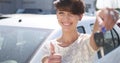 Young woman holding keys to new car auto and smiling at camera Royalty Free Stock Photo