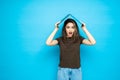 Young woman holding a laptop over his head isolated on a blue background Royalty Free Stock Photo