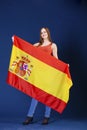 Young woman holding a large Spanish flag