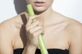 Young woman holding a leek