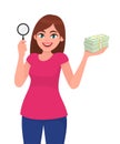 Young woman holding magnifying glass. Girl showing cash, money, currency notes in hand. Female character design illustration. Royalty Free Stock Photo