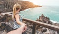 Young woman holding man by hand with atlantic ocean in background - Boyfriend following beloved girlfriend during summer holidays