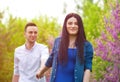 Young woman holding man`s hand and leading him on nature outdoor Royalty Free Stock Photo