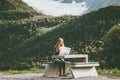 Young Woman holding map planning journey route in Norway sitting at the table Travel Lifestyle concept adventure vacations