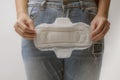 Young woman holding menstrual pad ,Women Period Product. Closeup asian female holding Sanitary Napkin, In Hand. Woman Holding