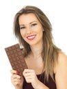 Young Woman Holding a Milk Chocolate Bar Royalty Free Stock Photo