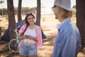 Young woman holding mobile phone while looking at man Royalty Free Stock Photo