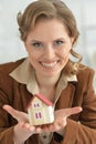 Young woman holding model of house in office Royalty Free Stock Photo