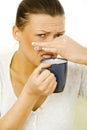 Young woman holding a mug with a disgusting drink