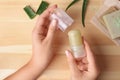 Young woman holding natural crystal alum deodorant at wooden table Royalty Free Stock Photo