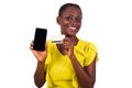 Young woman holding a new credit card with a mobile phone Royalty Free Stock Photo