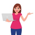 Young woman holding new laptop computer and presenting hand to copy space. Trendy girl using gadget and introducing gesture. Royalty Free Stock Photo