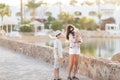 Young woman holding a newborn baby in her arms with teenager on the summer background.Family portrait. Mother and her sons. Baby g