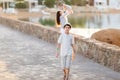 Young woman holding a newborn baby in her arms with teenager on the summer background.Family portrait. Mother and her sons. Baby g