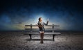 Young woman holding open book on bench Royalty Free Stock Photo