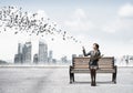 Young woman holding open book on wooden bench Royalty Free Stock Photo