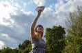 Young woman holding paper plane toward sky, low angle view Royalty Free Stock Photo