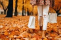 AI generated. Young woman holding paper shopping bag in autumn park in nature