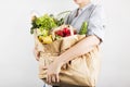 Young woman holding papers shopping bags on gray background Royalty Free Stock Photo