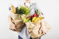 Young woman holding papers shopping bags on gray background Royalty Free Stock Photo