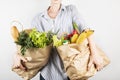 Young woman holding papers shopping bags on gray background Royalty Free Stock Photo